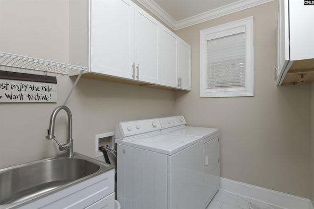 clothes washing area with washer and dryer, cabinets, sink, and crown molding