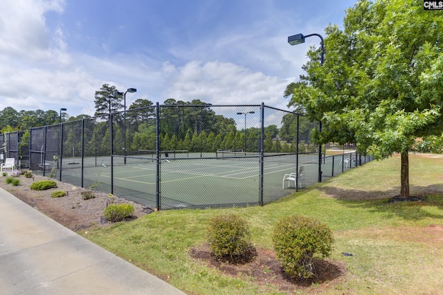 view of sport court featuring a yard