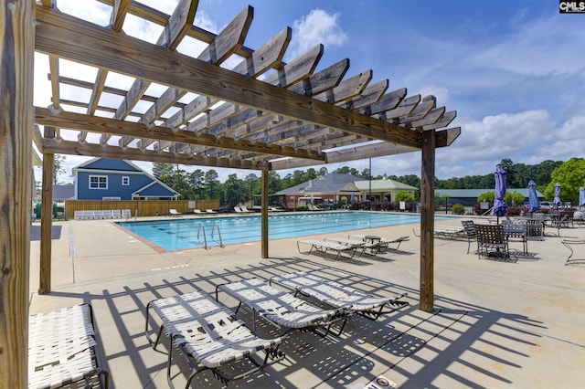 view of swimming pool featuring a patio area and a pergola