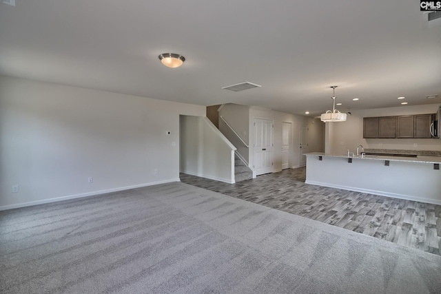 unfurnished living room featuring light carpet