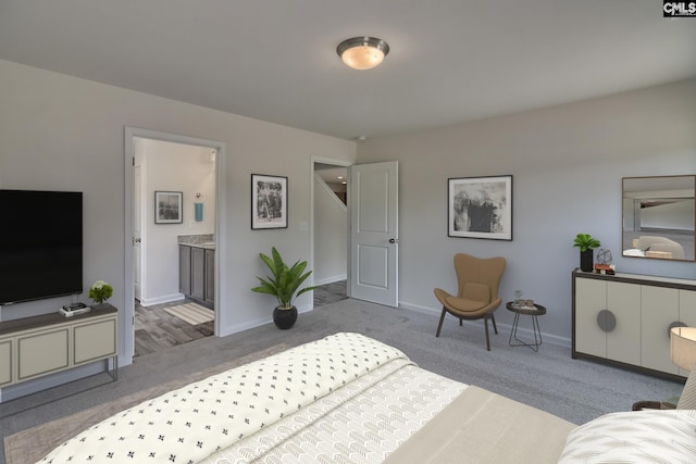 carpeted bedroom featuring connected bathroom