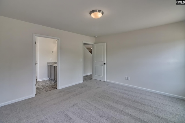 unfurnished room with light colored carpet