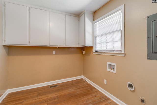 washroom with cabinets, washer hookup, light hardwood / wood-style floors, electric dryer hookup, and electric panel