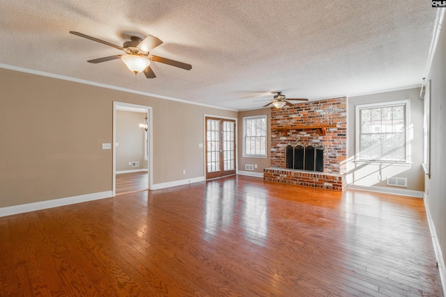 unfurnished living room featuring hardwood / wood-style floors and a textured ceiling