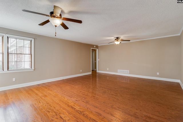 spare room with a textured ceiling, light hardwood / wood-style flooring, ceiling fan, and ornamental molding