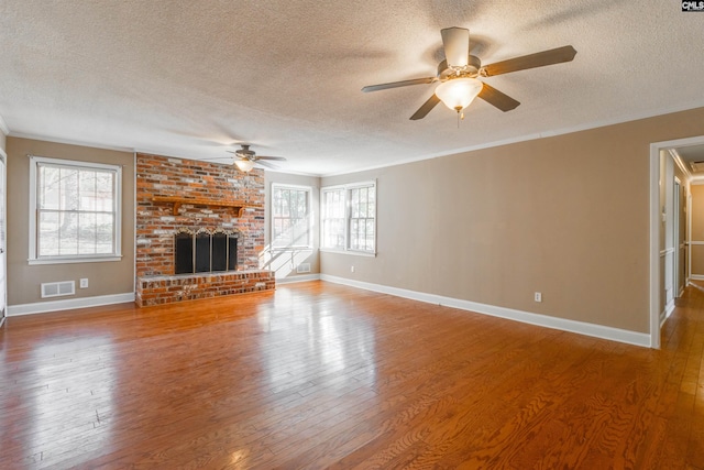 unfurnished living room featuring ceiling fan, wood-type flooring, and a textured ceiling