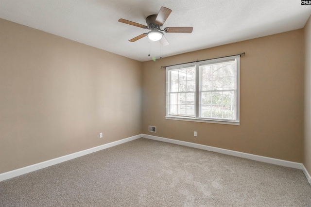 empty room featuring light carpet and ceiling fan