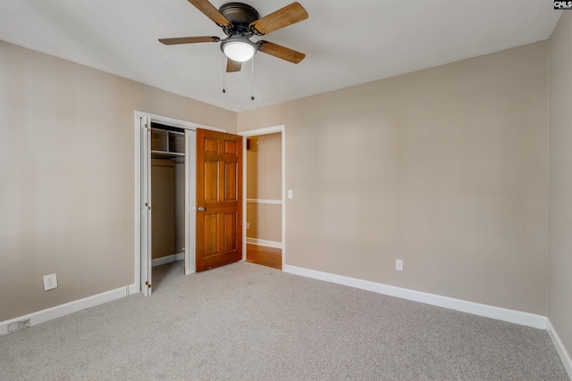 unfurnished bedroom with ceiling fan, light carpet, and a closet