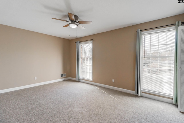 carpeted empty room featuring ceiling fan