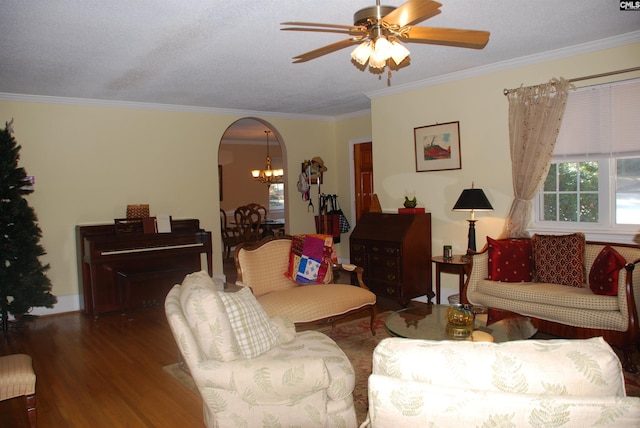 living room with a textured ceiling, ceiling fan with notable chandelier, hardwood / wood-style flooring, and crown molding