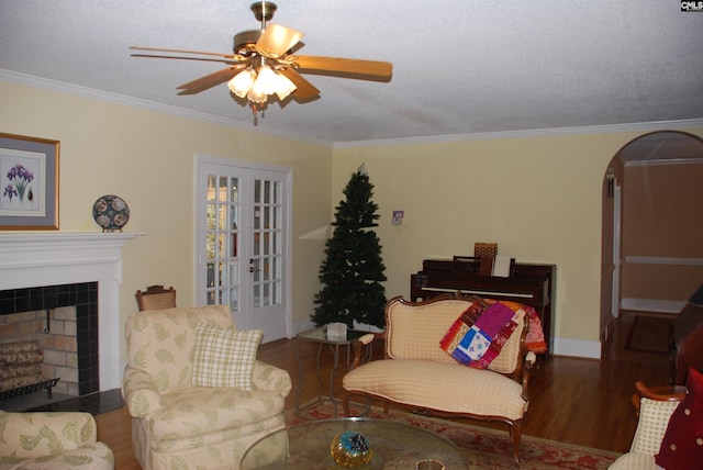 living room with wood-type flooring, crown molding, and french doors