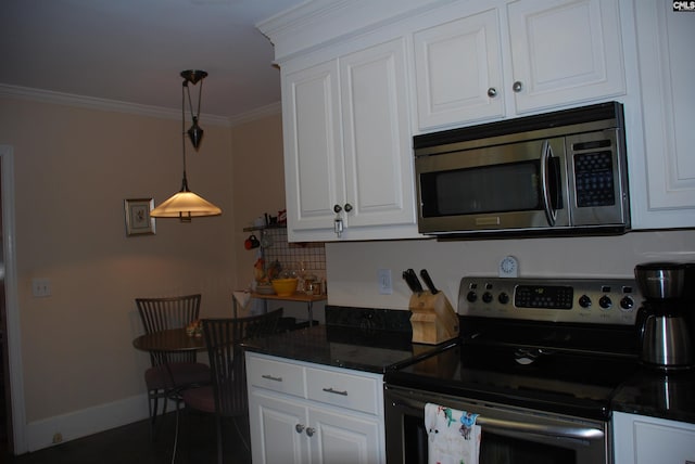 kitchen featuring backsplash, ornamental molding, stainless steel appliances, pendant lighting, and white cabinetry