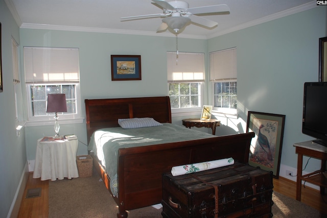 bedroom featuring ceiling fan, hardwood / wood-style flooring, and ornamental molding