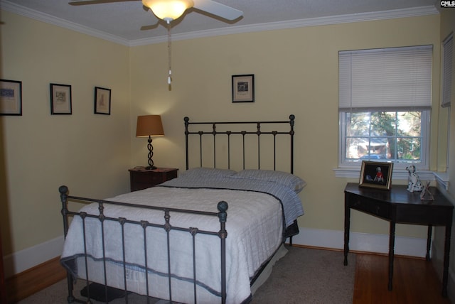 bedroom featuring carpet floors, ceiling fan, and crown molding