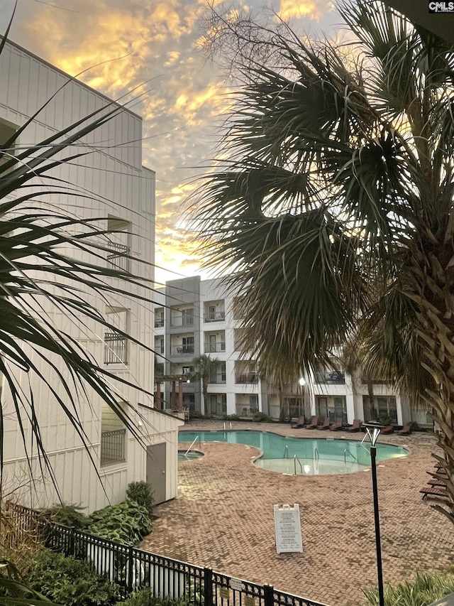 view of pool at dusk