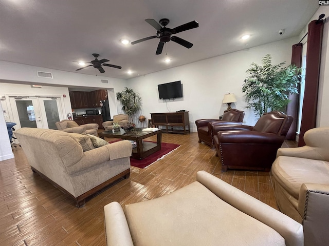 living room with ceiling fan and dark hardwood / wood-style flooring