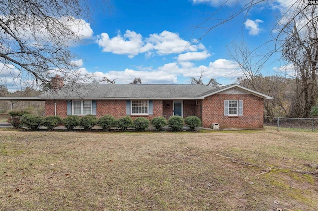 ranch-style home with a front lawn