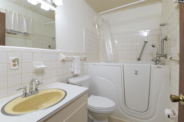 full bathroom featuring vanity, toilet, shower / bathtub combination with curtain, and tile walls