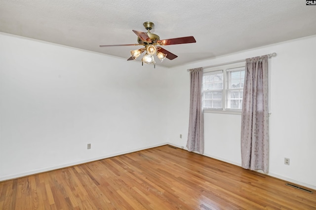 unfurnished room featuring ceiling fan, a textured ceiling, and light wood-type flooring