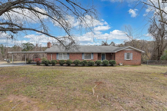 ranch-style home with a front lawn and a carport