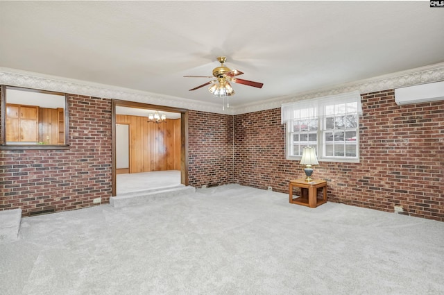 unfurnished living room featuring a wall mounted air conditioner, ornamental molding, carpet floors, and brick wall