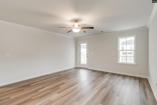 empty room with light hardwood / wood-style floors, a wealth of natural light, ornamental molding, and ceiling fan