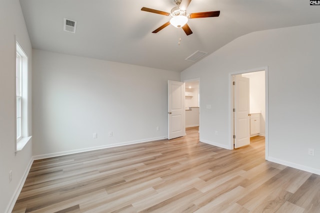 unfurnished bedroom with ceiling fan, vaulted ceiling, and light hardwood / wood-style flooring