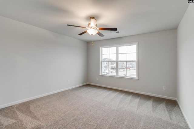 empty room with ceiling fan and carpet