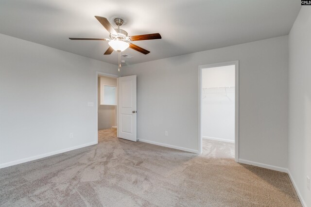 empty room with ceiling fan and light colored carpet