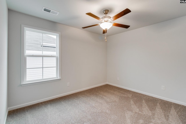 carpeted spare room with ceiling fan