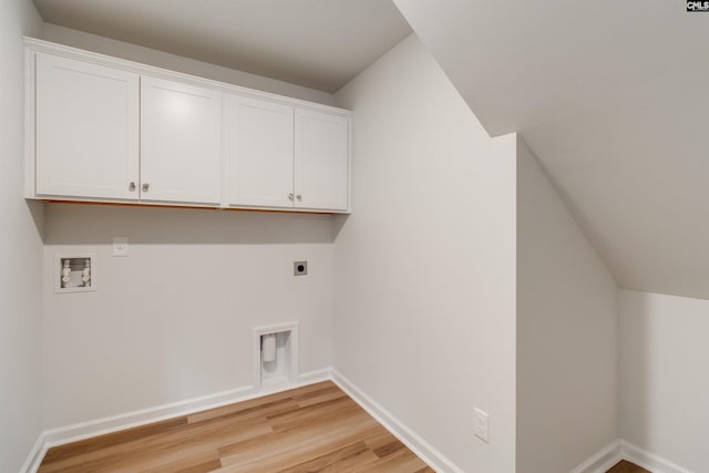 laundry area with washer hookup, electric dryer hookup, cabinets, and light hardwood / wood-style flooring