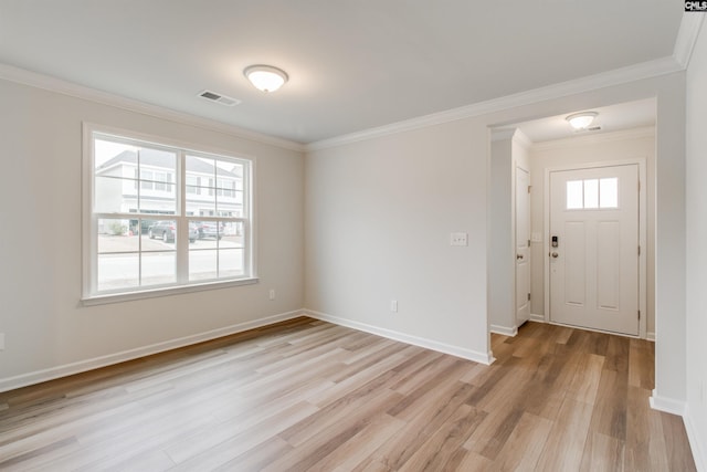 entryway featuring light wood-type flooring and ornamental molding