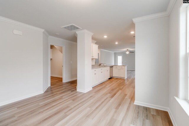 unfurnished living room featuring ceiling fan, sink, crown molding, and light hardwood / wood-style flooring