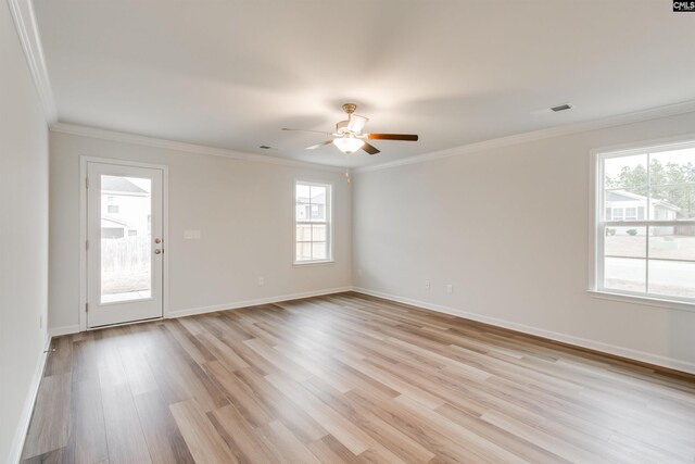 unfurnished room with light wood-type flooring, a wealth of natural light, crown molding, and ceiling fan