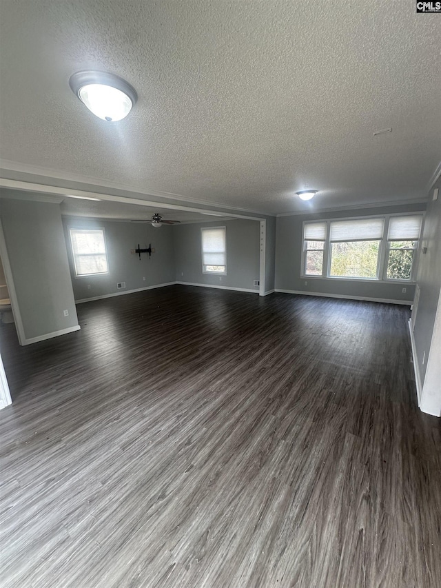 unfurnished living room with ceiling fan, a textured ceiling, and dark hardwood / wood-style flooring
