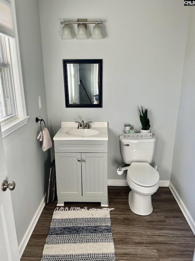 bathroom with vanity, hardwood / wood-style floors, and toilet