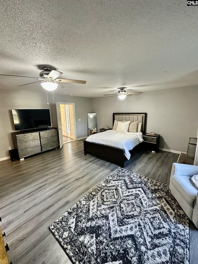 bedroom featuring hardwood / wood-style flooring, ceiling fan, and a textured ceiling