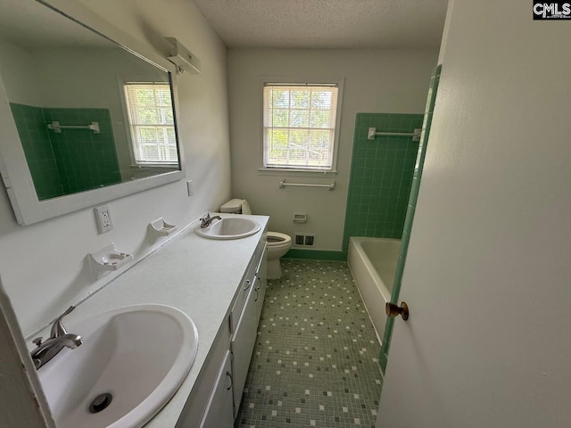 bathroom featuring visible vents, a sink, a healthy amount of sunlight, and toilet