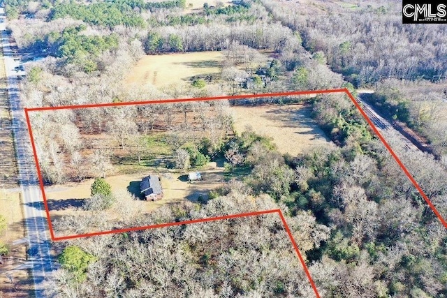 bird's eye view featuring a wooded view
