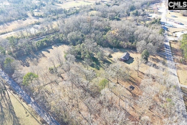 birds eye view of property with a wooded view