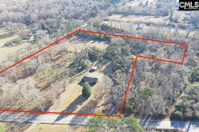 aerial view with a rural view and a wooded view