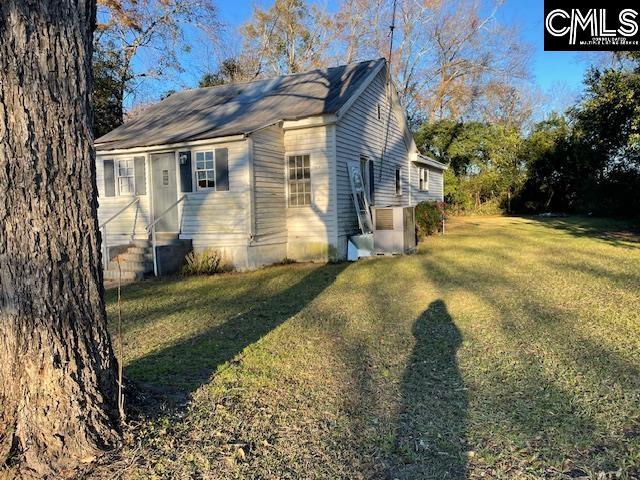 view of property exterior with a yard