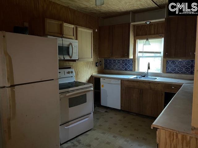 kitchen featuring white appliances, ceiling fan, and sink