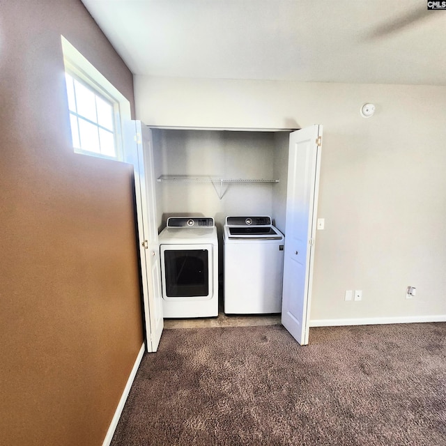 laundry area featuring dark carpet and washing machine and clothes dryer