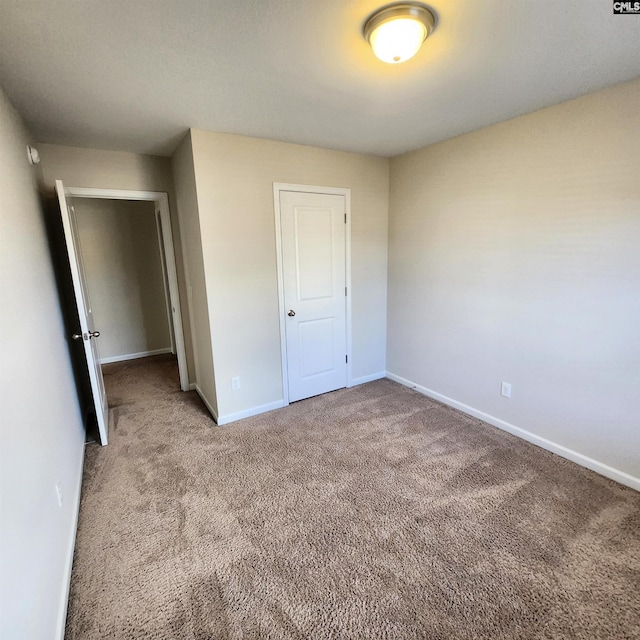 unfurnished bedroom featuring carpet flooring and a closet