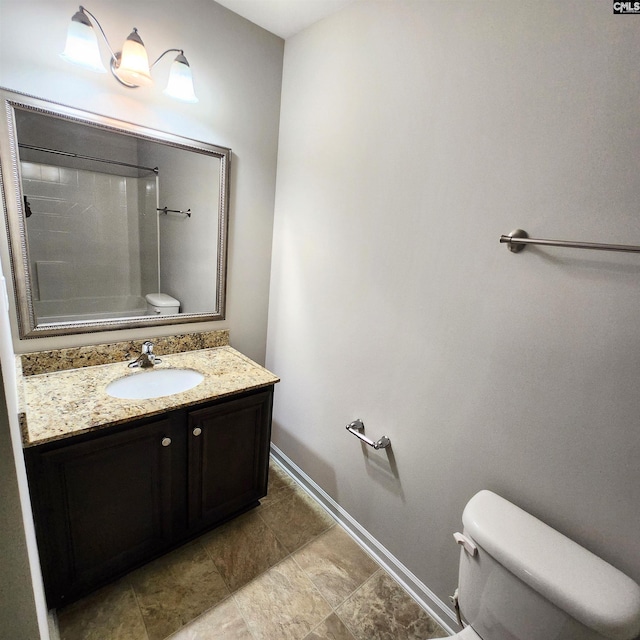 bathroom featuring a shower, vanity, and toilet