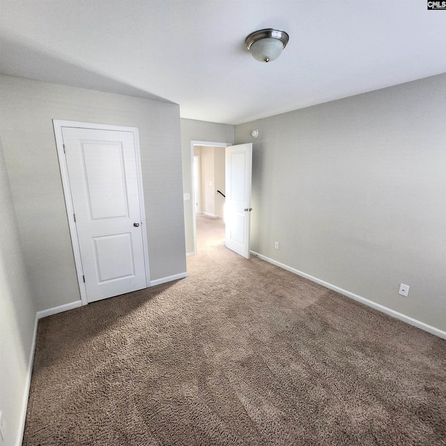 unfurnished bedroom with a closet and carpet floors