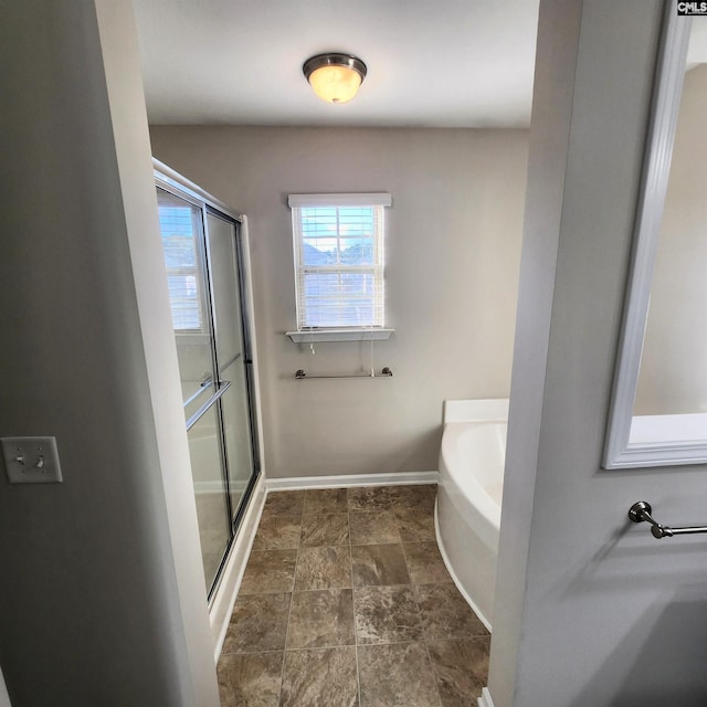 bathroom featuring shower with separate bathtub