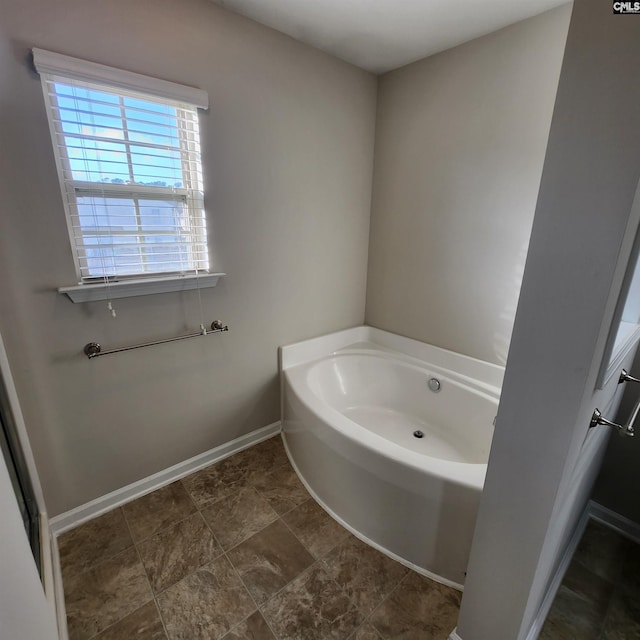 bathroom with a tub to relax in