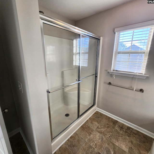 bathroom featuring a shower with door